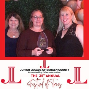 Center for Hope & Safety Executive Director Julye Myner accepting Community Partner Award from the Junior League of Bergen County